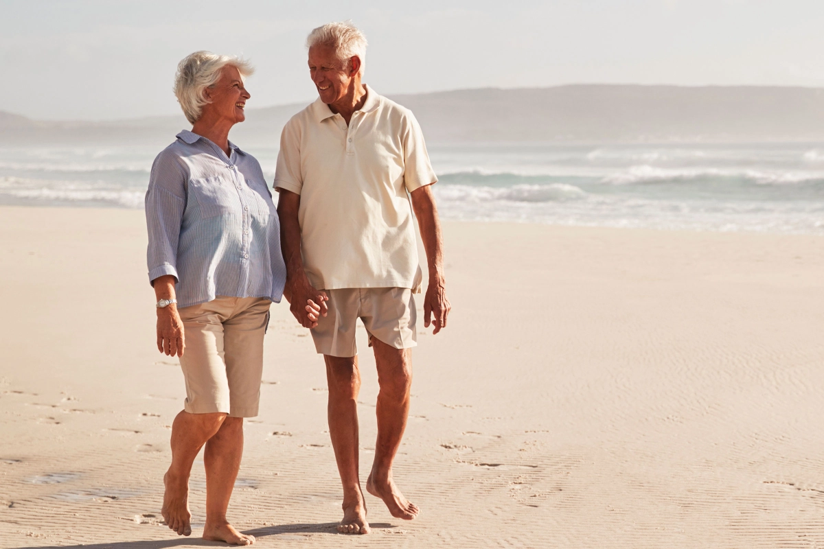 Senior Couple Walking on Beach