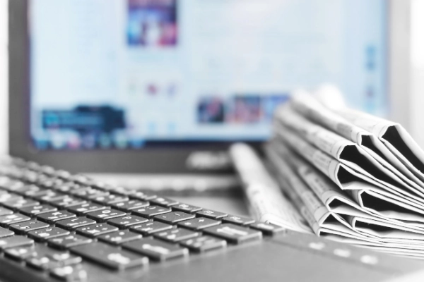 Computer, keyboard and newspaper